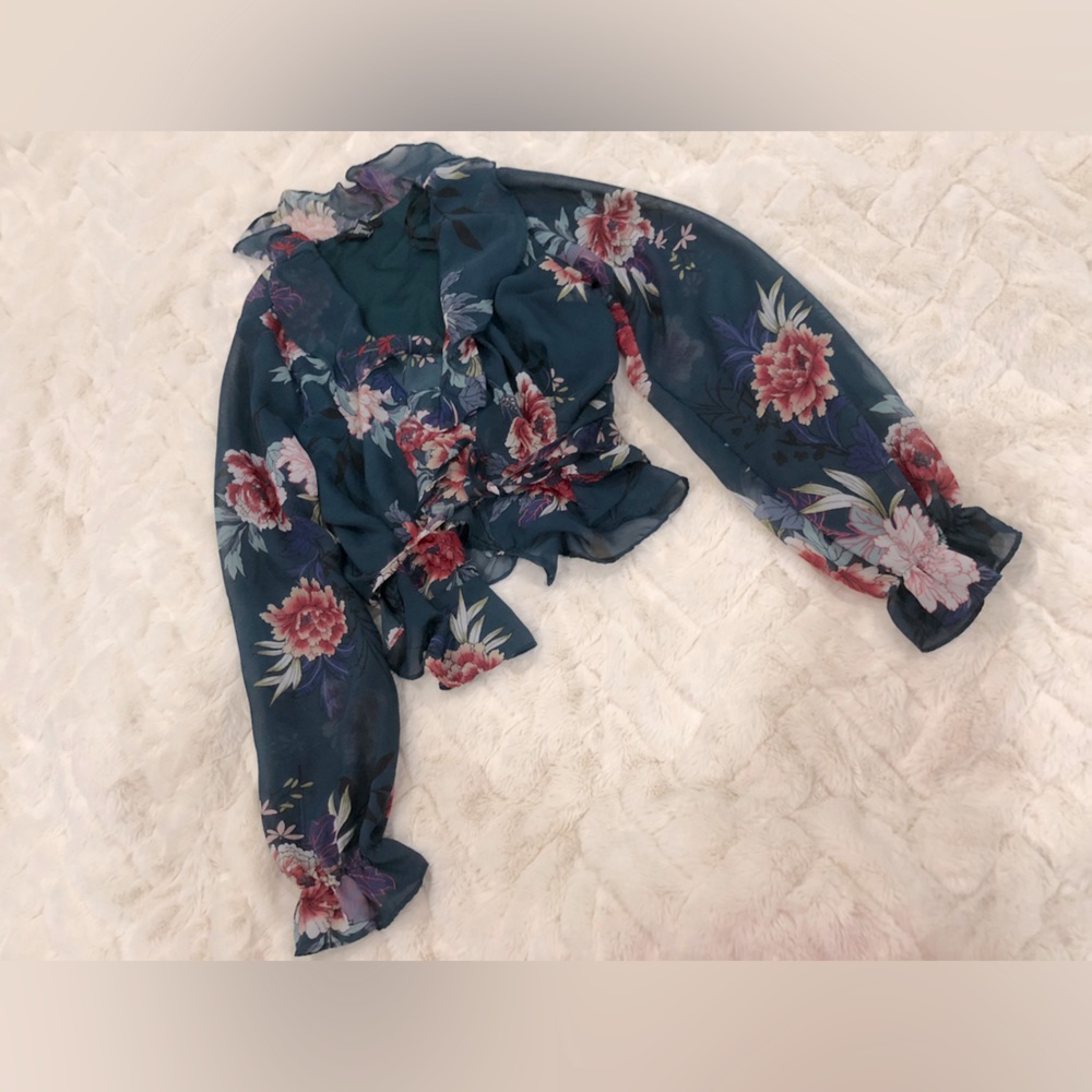 Floral crop top with sheer sleeves; button for front closure, ruffle trim bottom